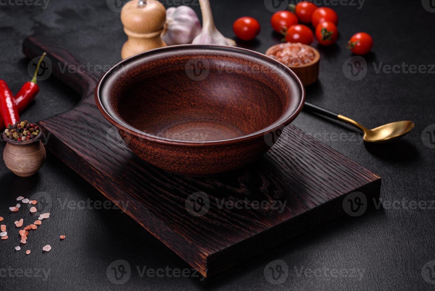 An empty plate with a knife, fork or spoon with a wooden cutting board photo