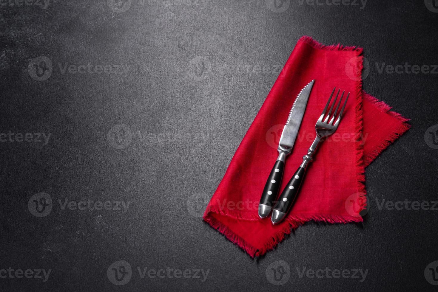 Christmas table setting with empty black ceramic plate, fir tree and black accessories photo