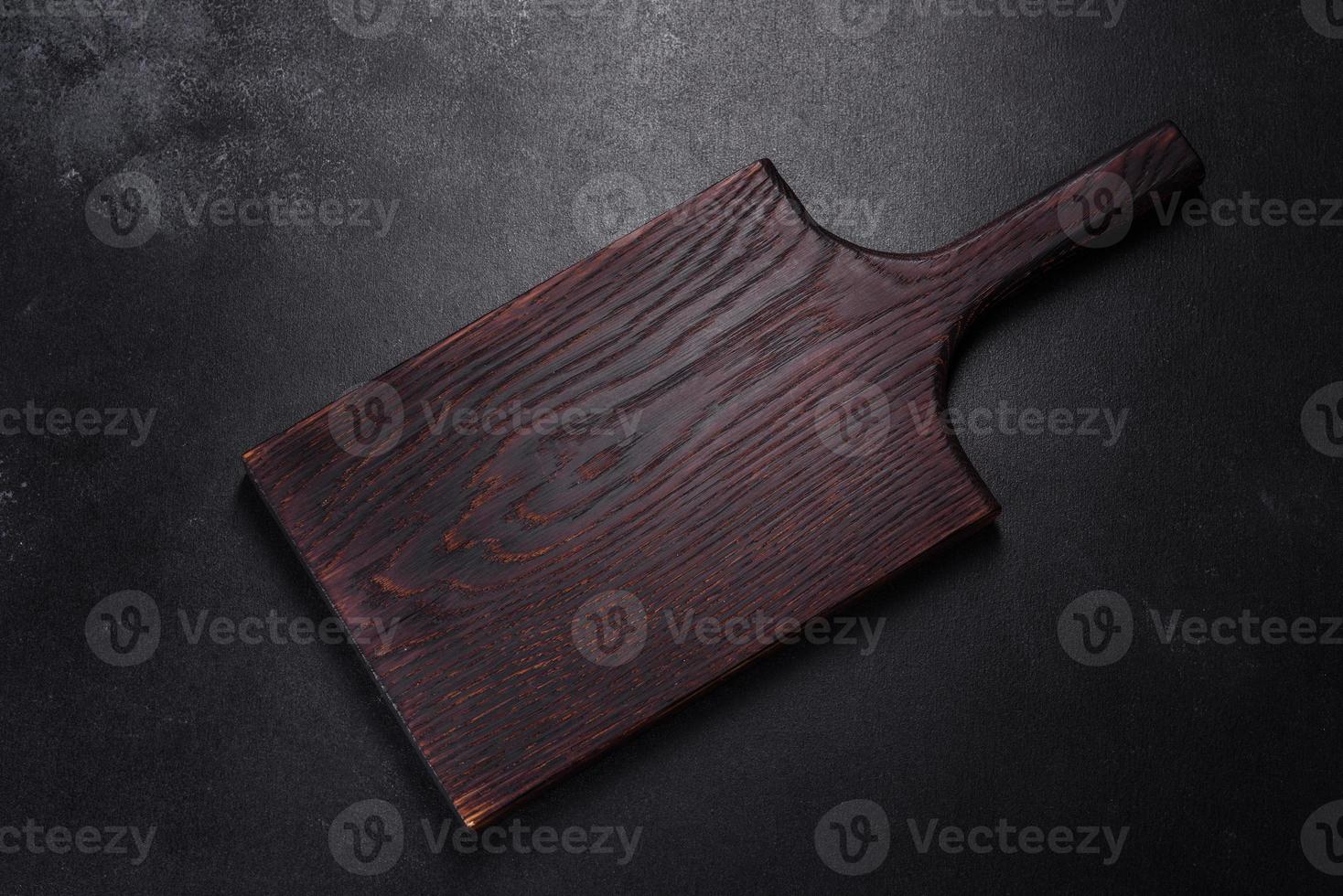 An empty plate with a knife, fork or spoon with a wooden cutting board photo