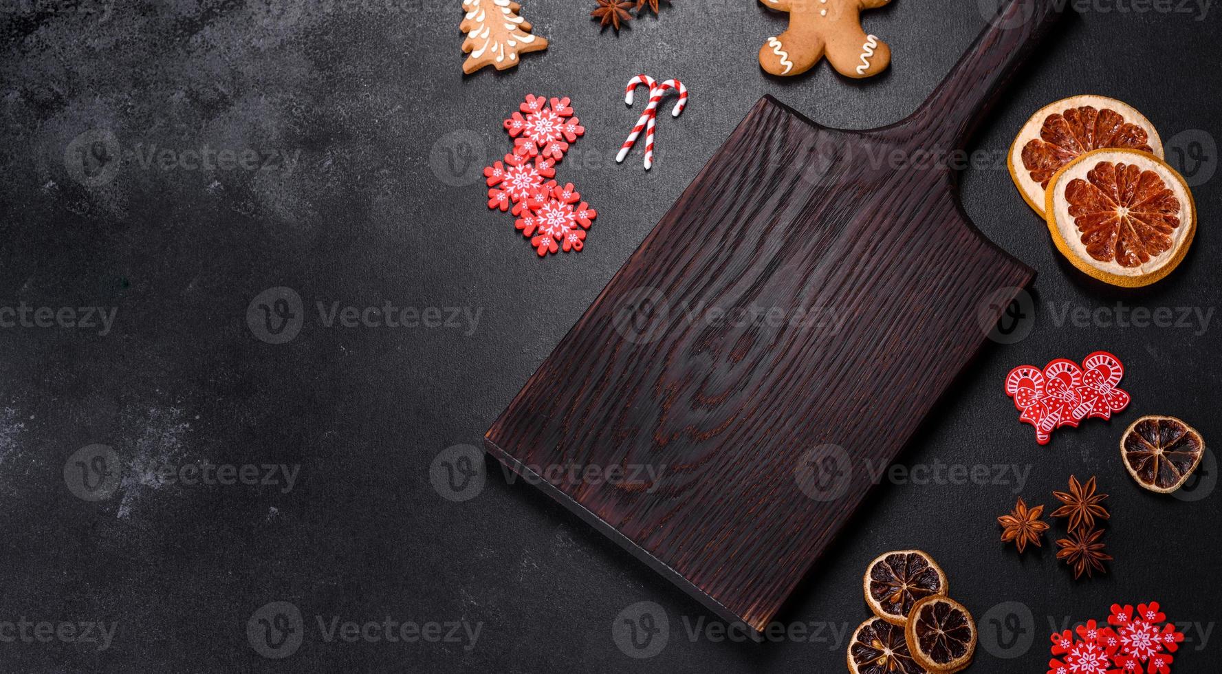 Christmas table setting with empty black ceramic plate, fir tree and black accessories photo