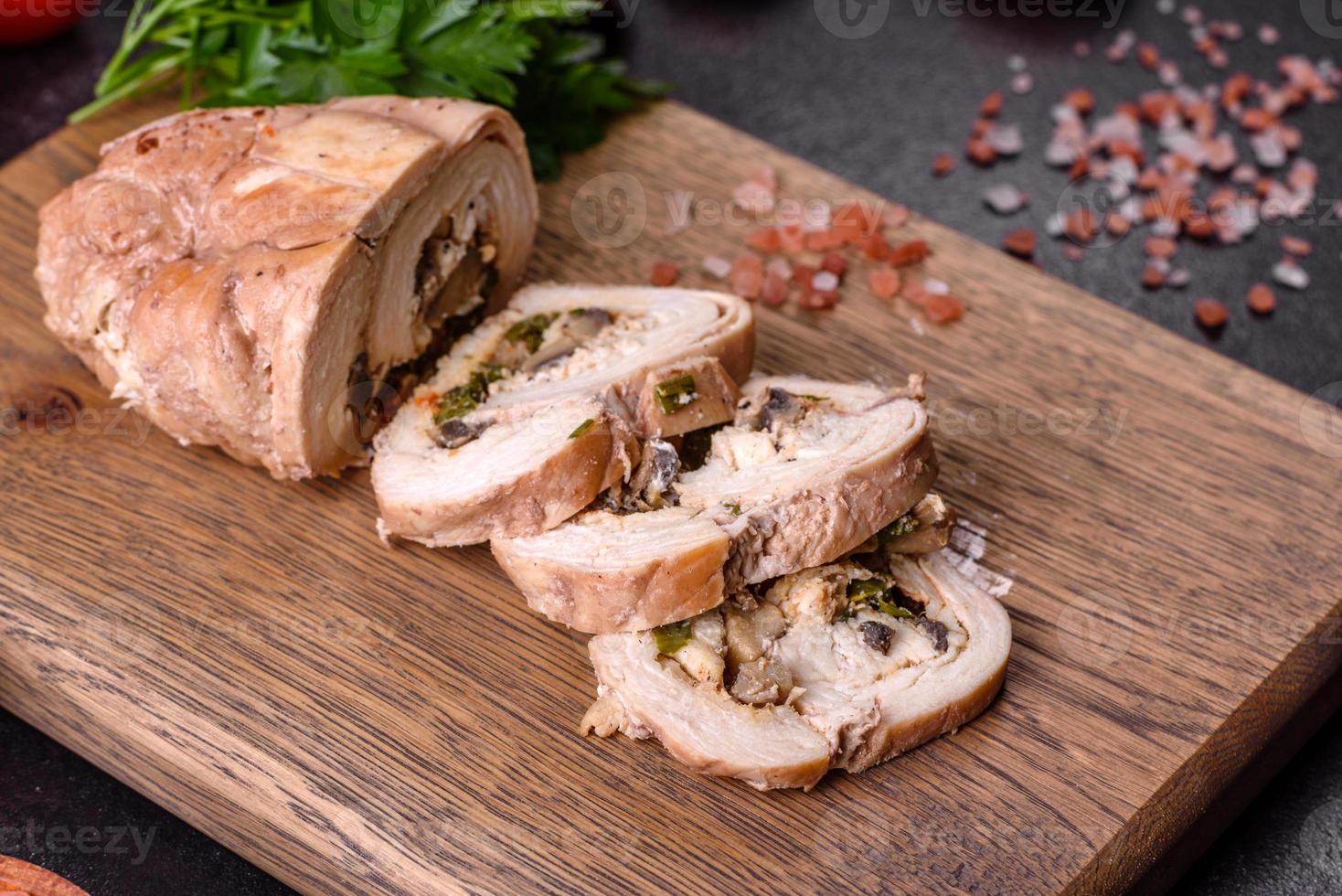 Delicious fresh meat roll made from chicken fillet, mushrooms, spices and herbs photo