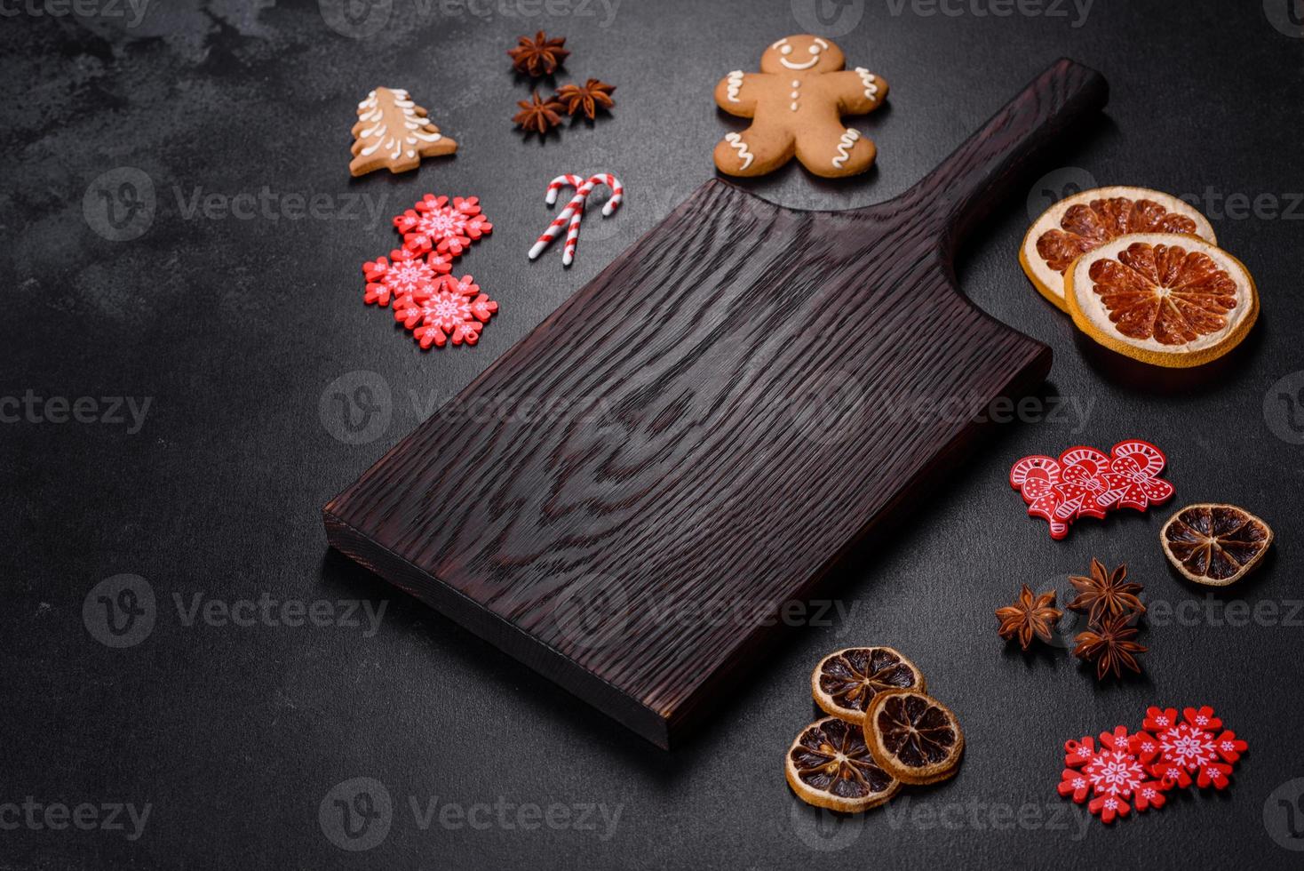 Christmas table setting with empty black ceramic plate, fir tree and black accessories photo