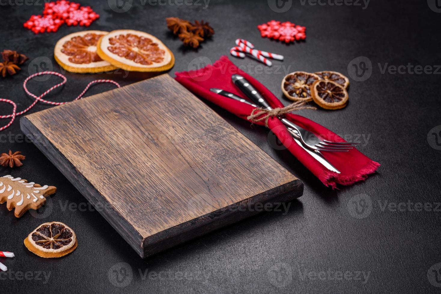 Christmas table setting with empty black ceramic plate, fir tree and black accessories photo