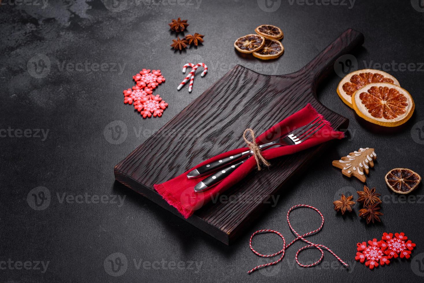 Christmas table setting with empty black ceramic plate, fir tree and black accessories photo