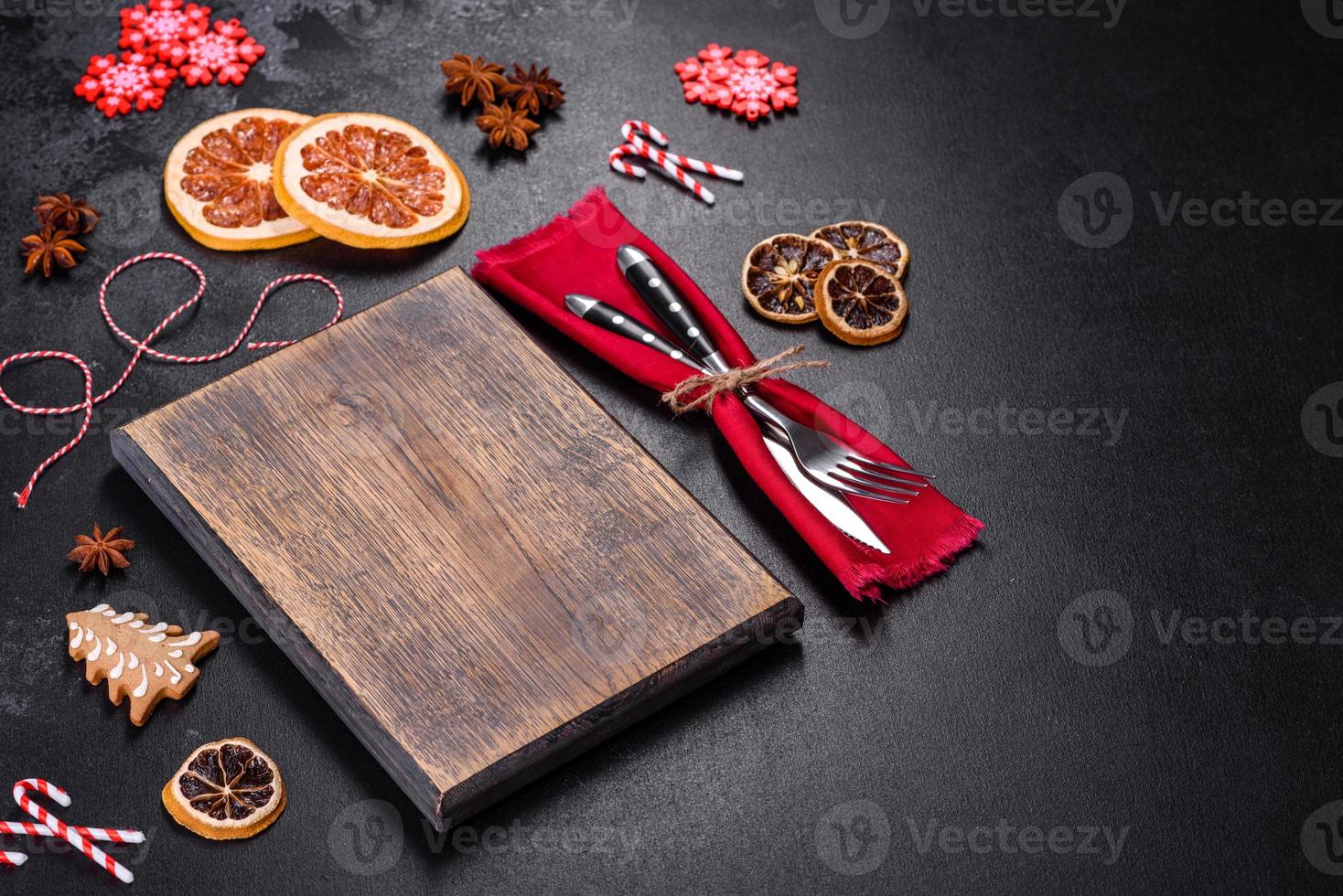 Christmas table setting with empty black ceramic plate, fir tree and black accessories photo