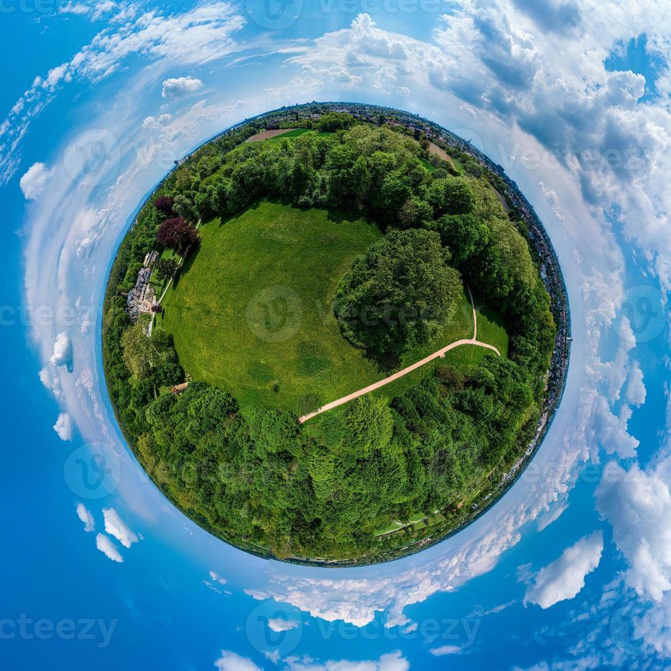 Little planet panoramic aerial view. Green grass ball. photo