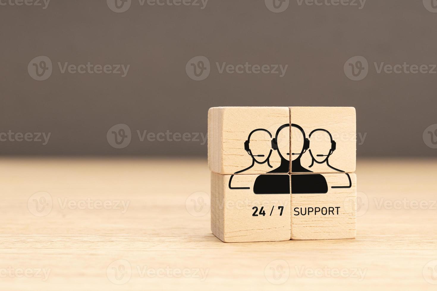 24-7 Customer support concept. Group of wooden block with Group of Call Center Workers icon. Copy space photo