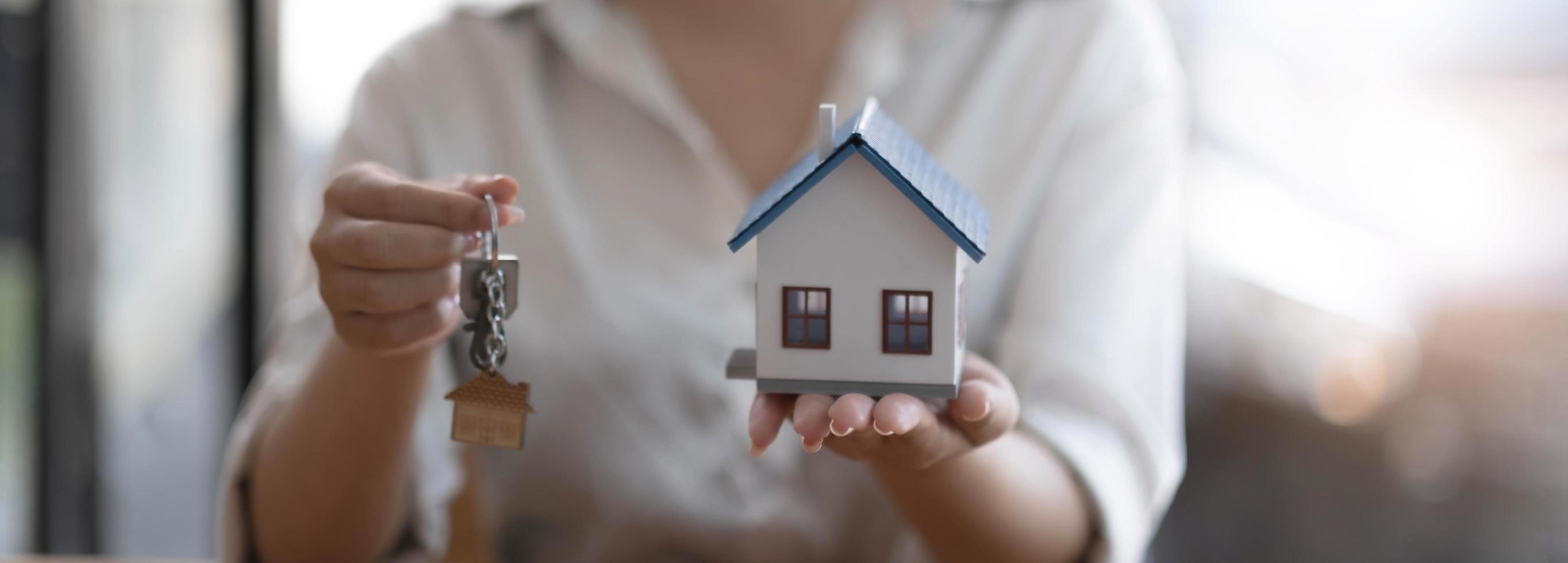 House model and key on table for finance and banking concept.Home purchase mortgage concept. photo