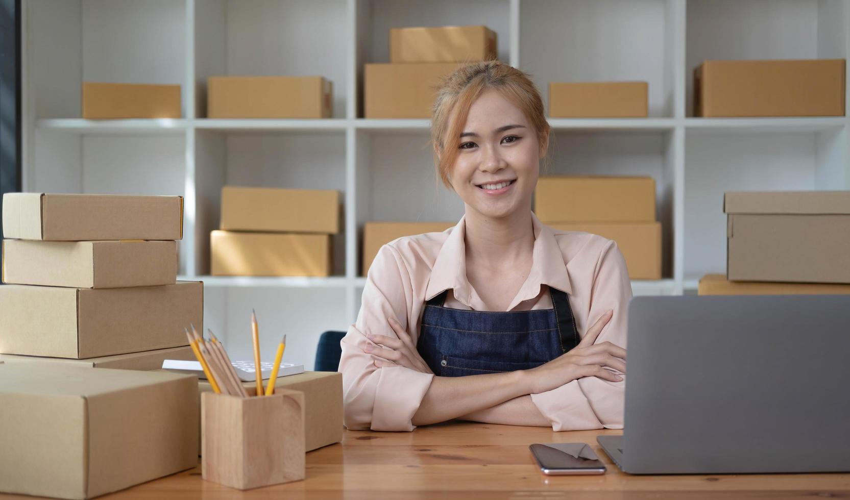 Portrait of beautiful owner asian woman freelancer sme business online shopping working and look at camara - Business online shipping and delivery photo