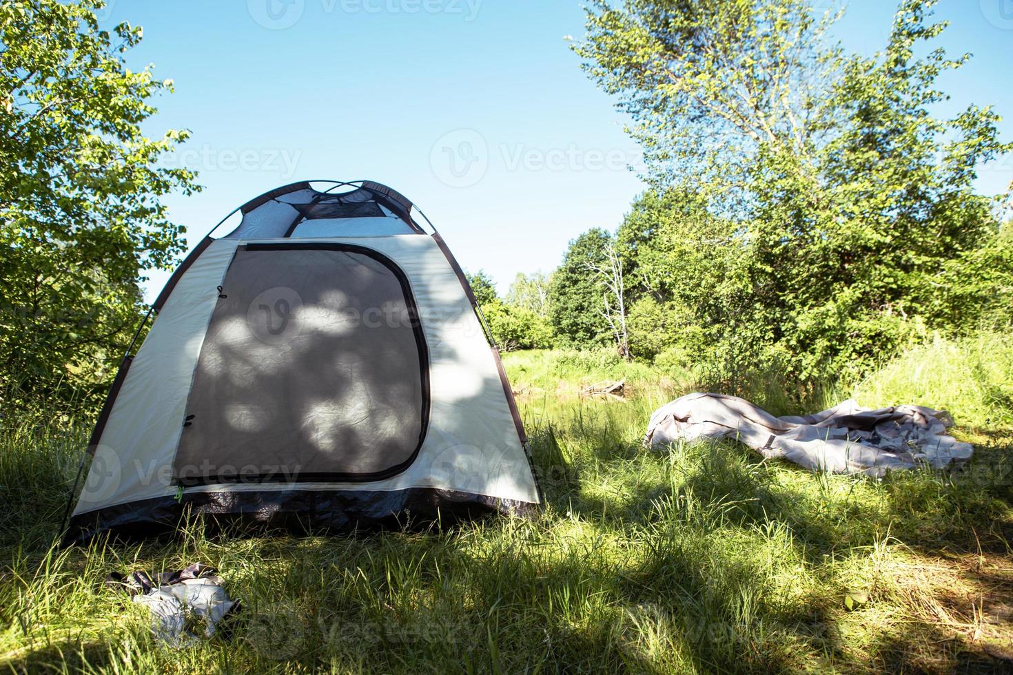 Installed tourist tent in a camping in nature in the forest. Domestic tourism, active summer holidays, family adventures. Ecotourism, sport, hike. Copy space, mock up photo