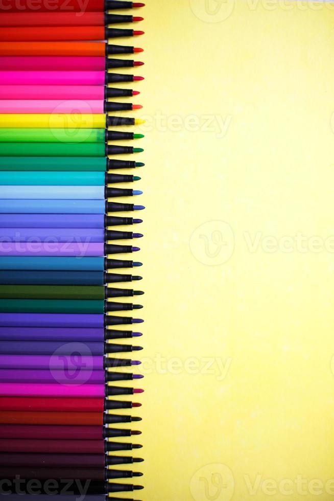 A set of markers with a large number of shades and halftones on a yellow background with space for text. photo