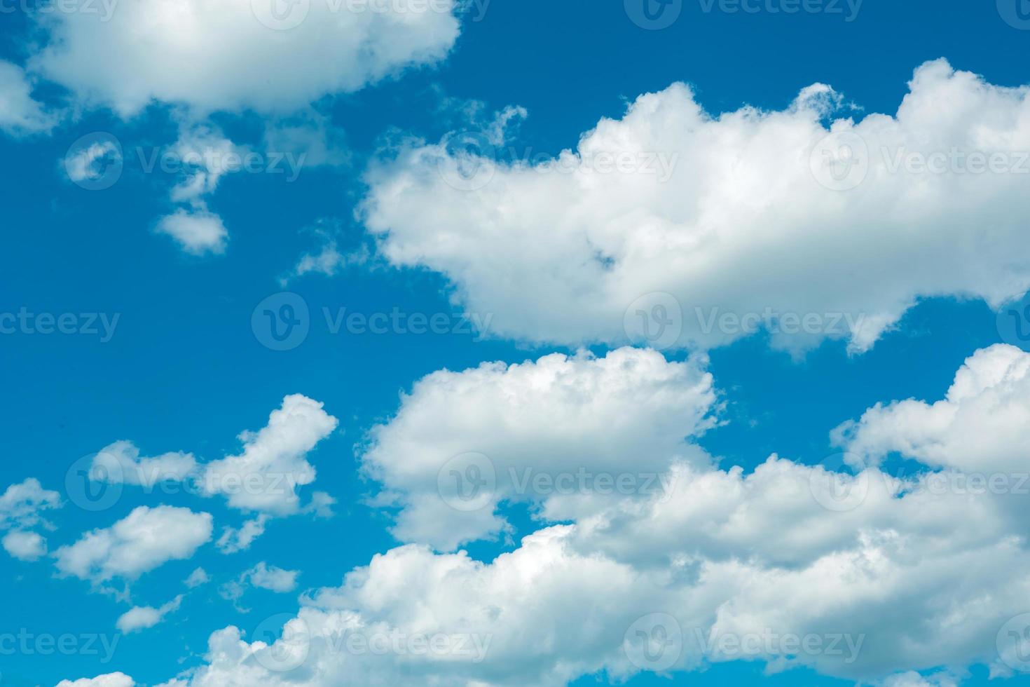 White cumulus clouds in a blue sky. Backgrounds with a pattern of high-beam clouds. Weather, seasonality, ecology, clear sky. Peace photo