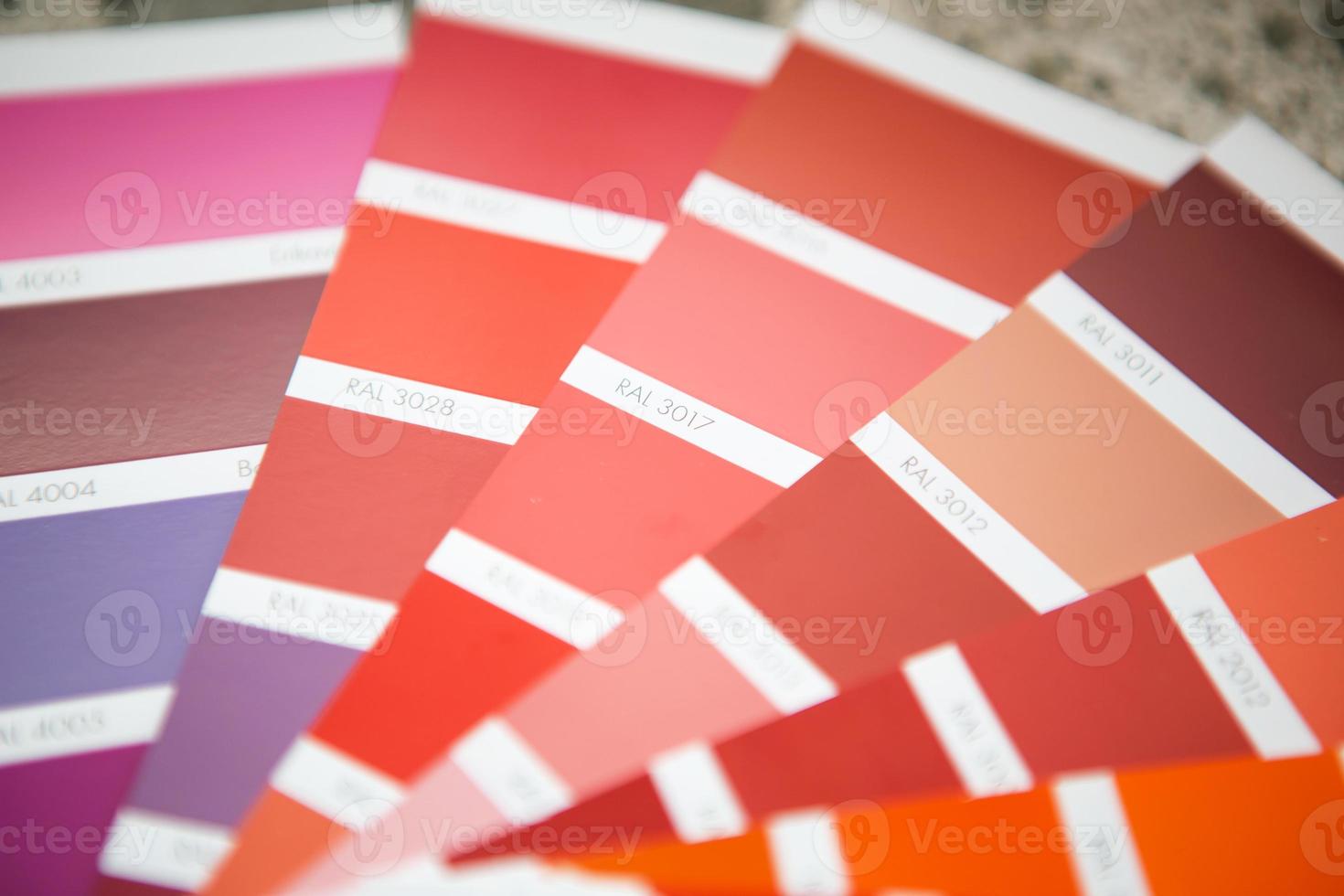 Selection of the paint color for decorative home repairs to the palette with layouts. A fan of shades in your hand inside the home. Repair and construction, paint and varnish coating photo