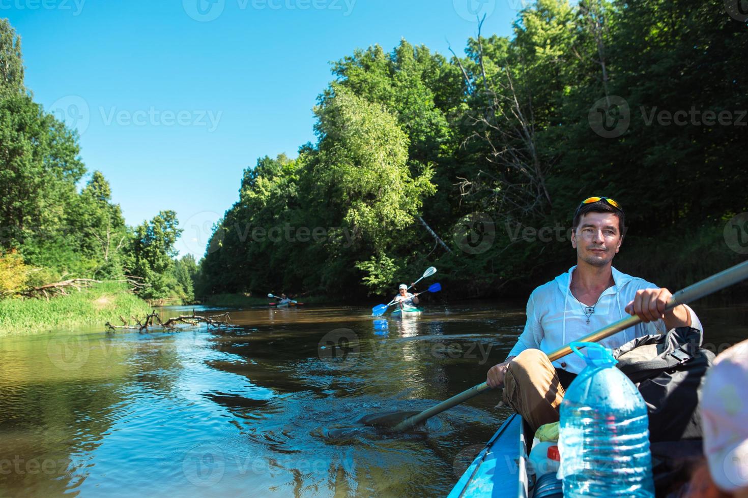 Family kayak trip. Father and daughter, and elderly couple senior and seniora rowing boat on the river, a water hike, a summer adventure. Eco-friendly and extreme tourism, active and healthy lifestyle photo