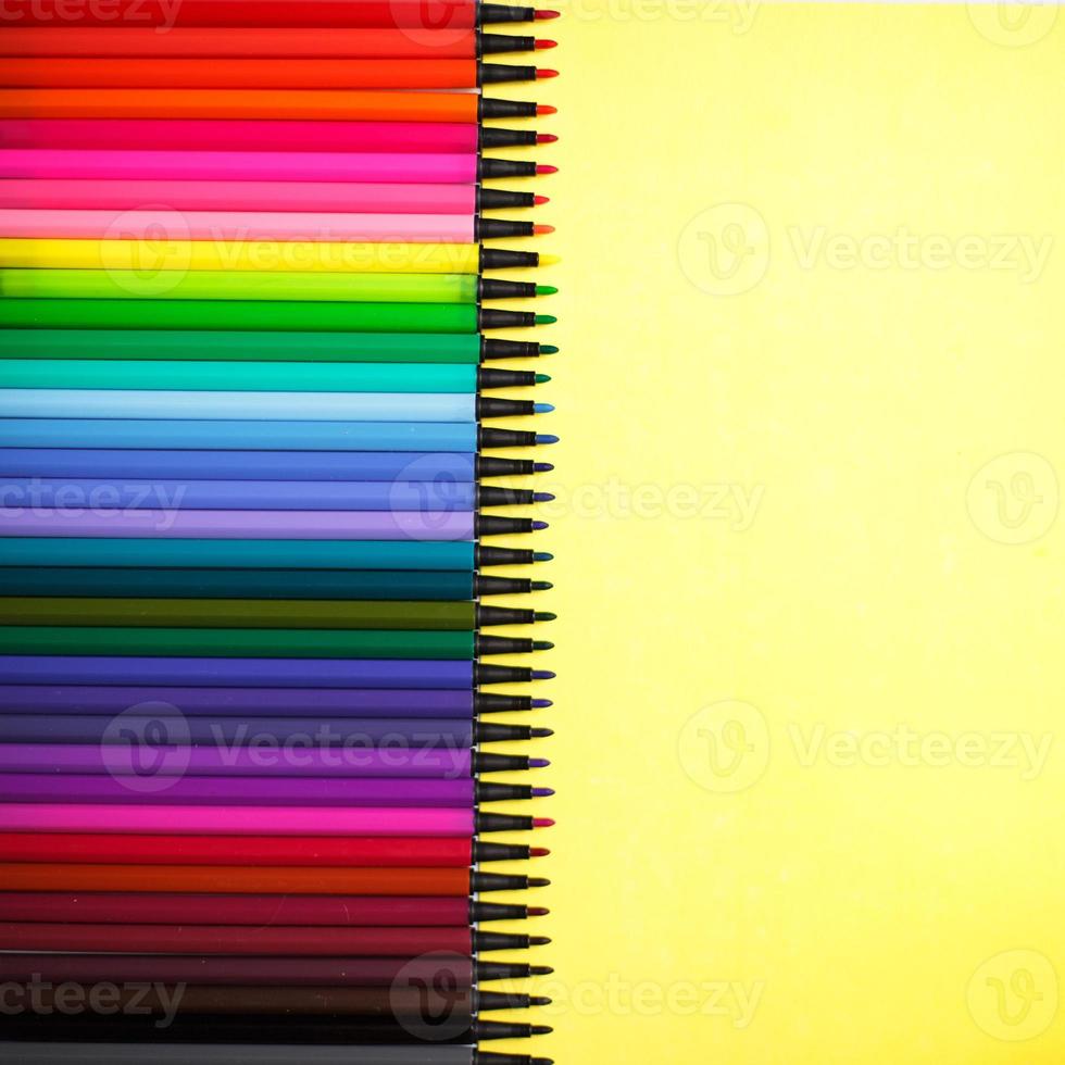 A set of markers with a large number of shades and halftones on a yellow background with space for text. photo