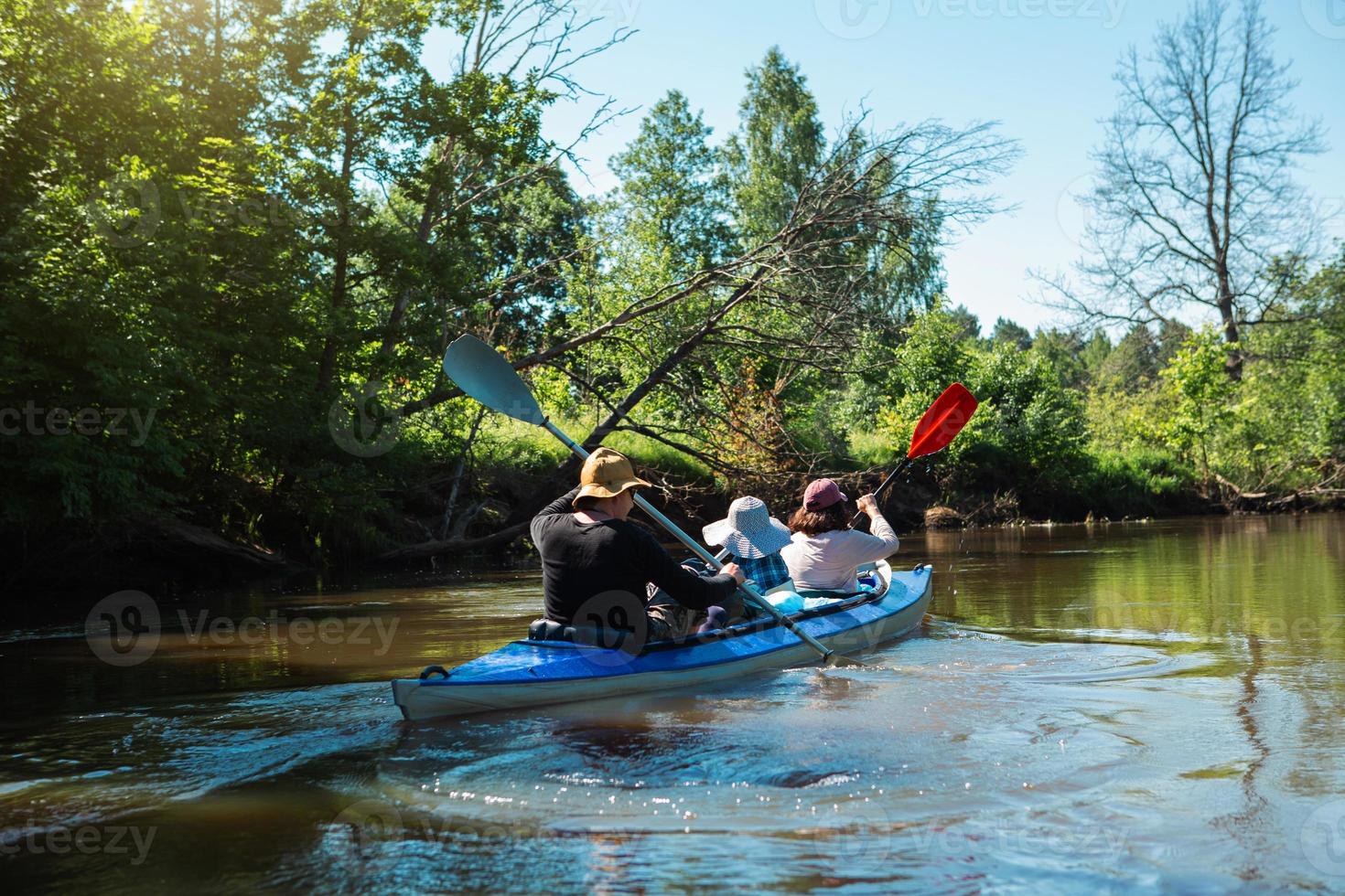 Man and woman couple in family kayak trip rowing boat on the river, a water hike, a summer adventure. Eco-friendly and extreme tourism, active and healthy lifestyle photo