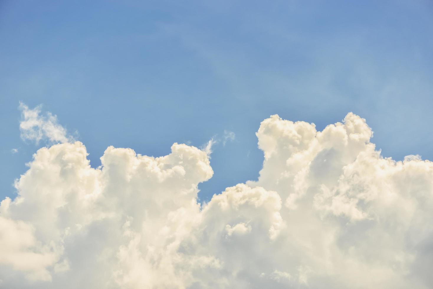 Fantastic soft white clouds against blue sky background photo