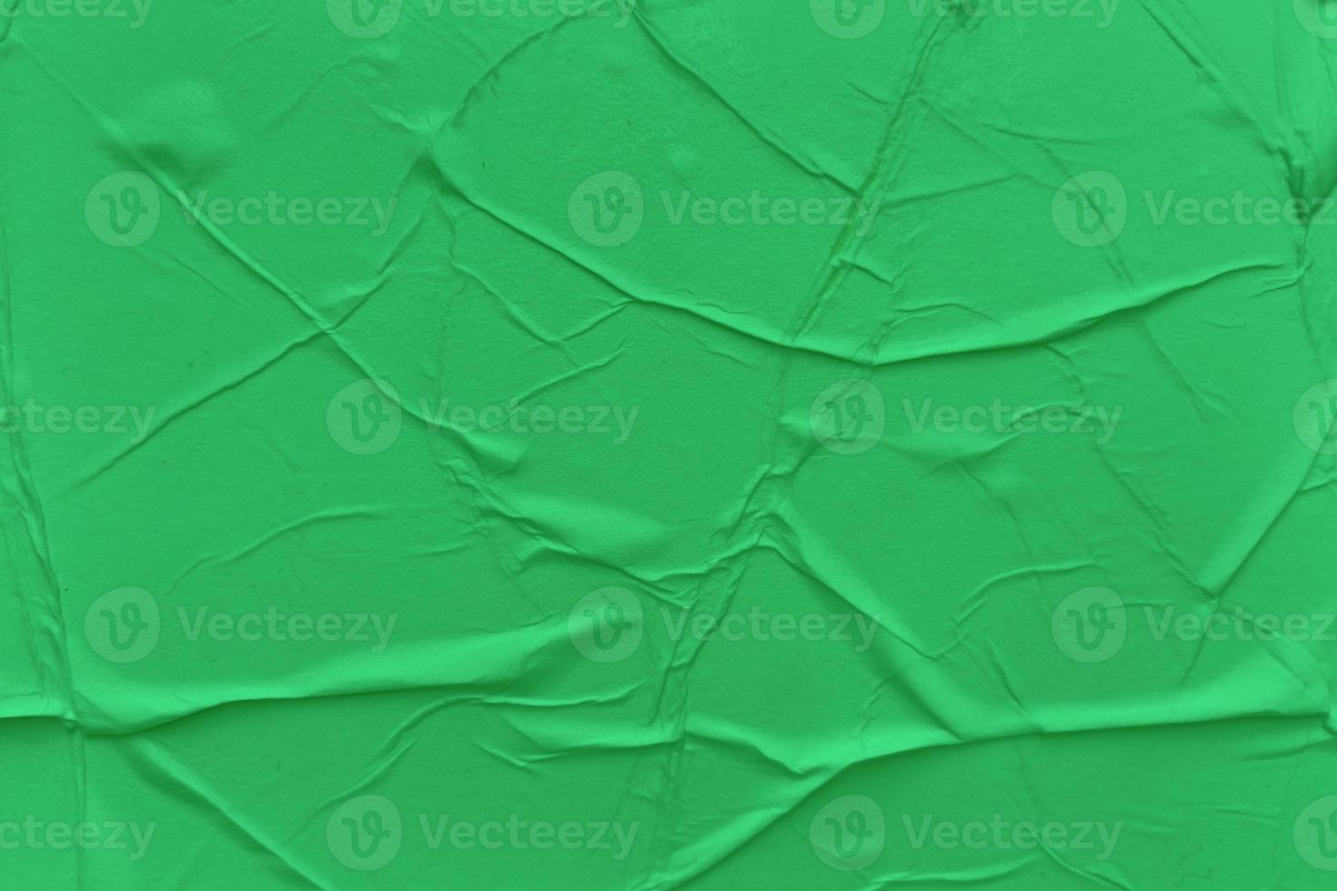 Blank green paper is crumpled texture background. Crumpled paper texture backgrounds for various purposes photo