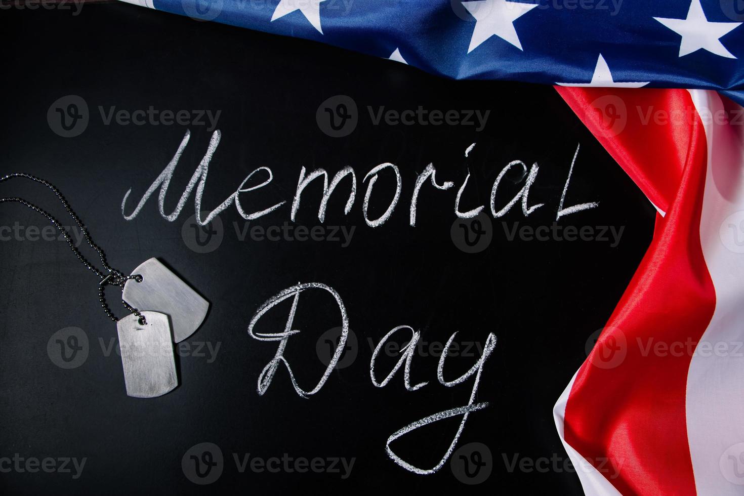 USA Memorial Day concept. American flag and dog tags on black background. Handwritten lettering on chalkboard. photo