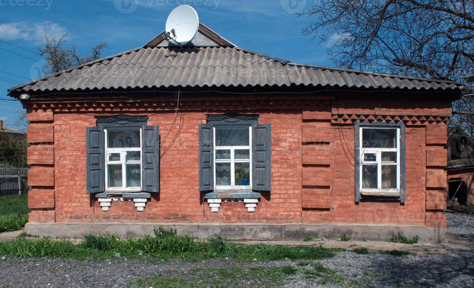 old house and satellite dish photo