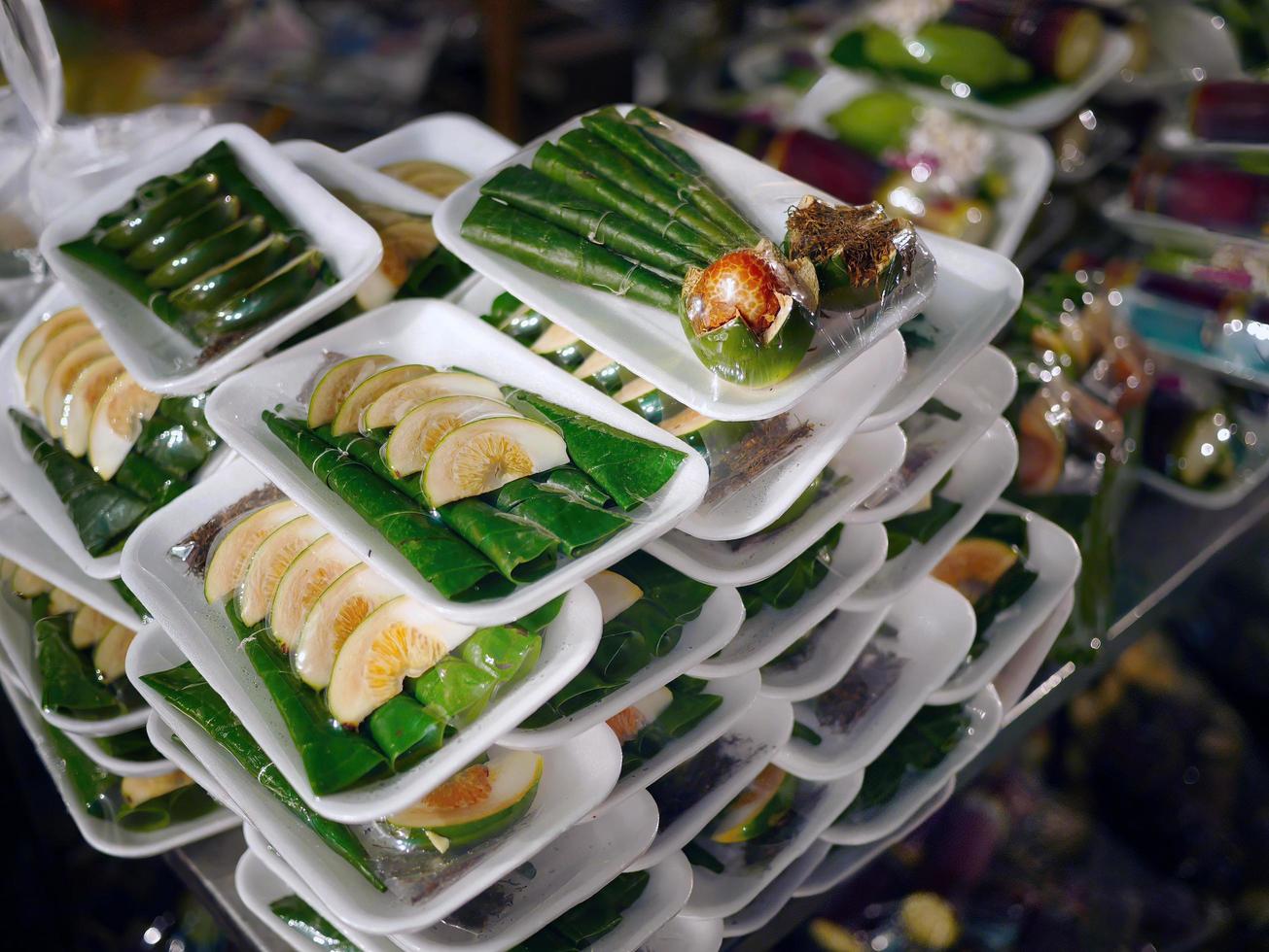 Stack of edible fresh Piper betel palm set for selling in night market photo
