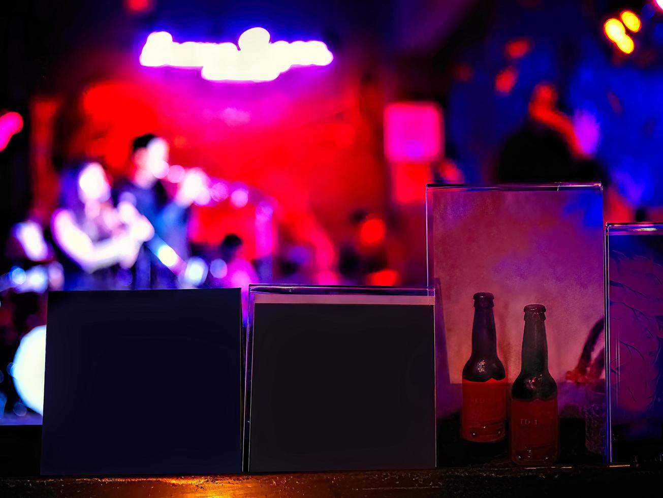 noche desenfocada de músico en el bar de jazz con publicidad de tarjetas en blanco foto