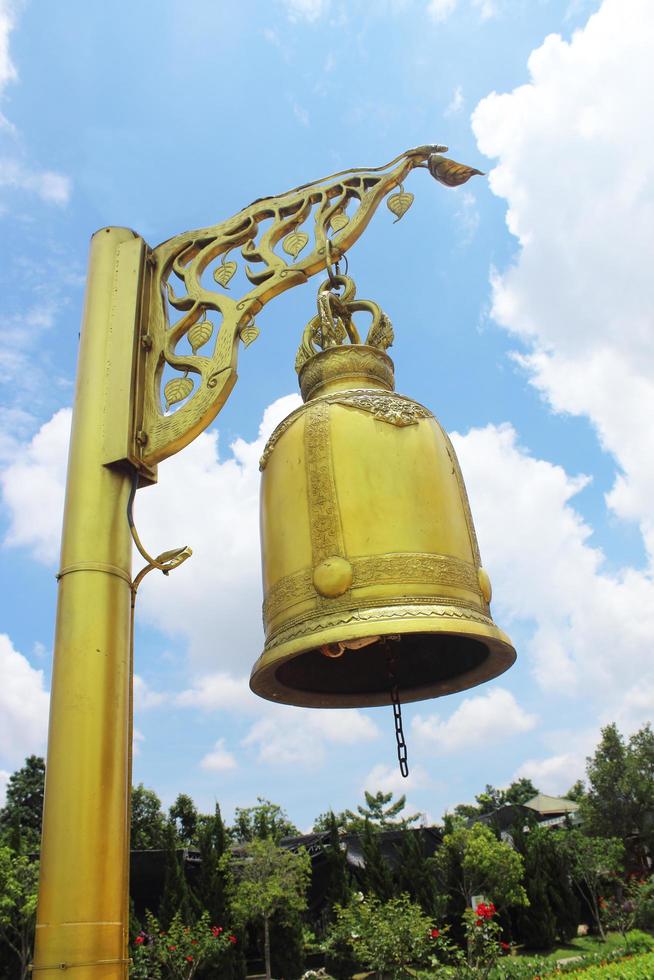 Golden bell isolated on blue sky photo