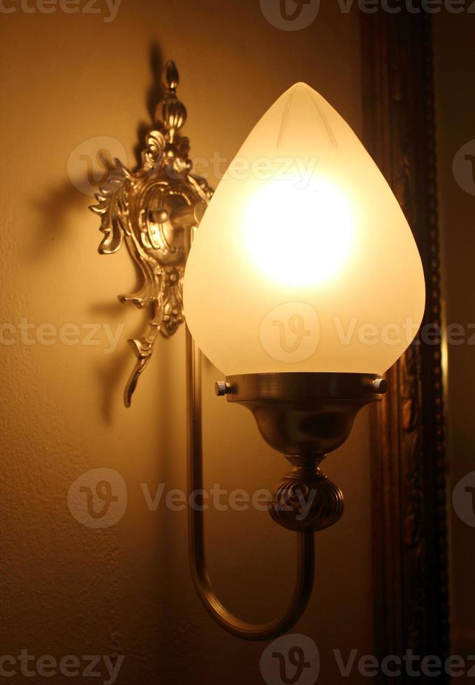 Wall lamp with a shade on the background photo