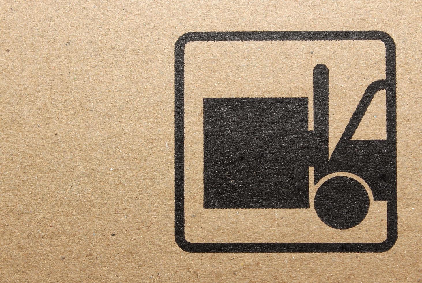 Fine image close-up of grunge black fragile symbol on cardboard photo