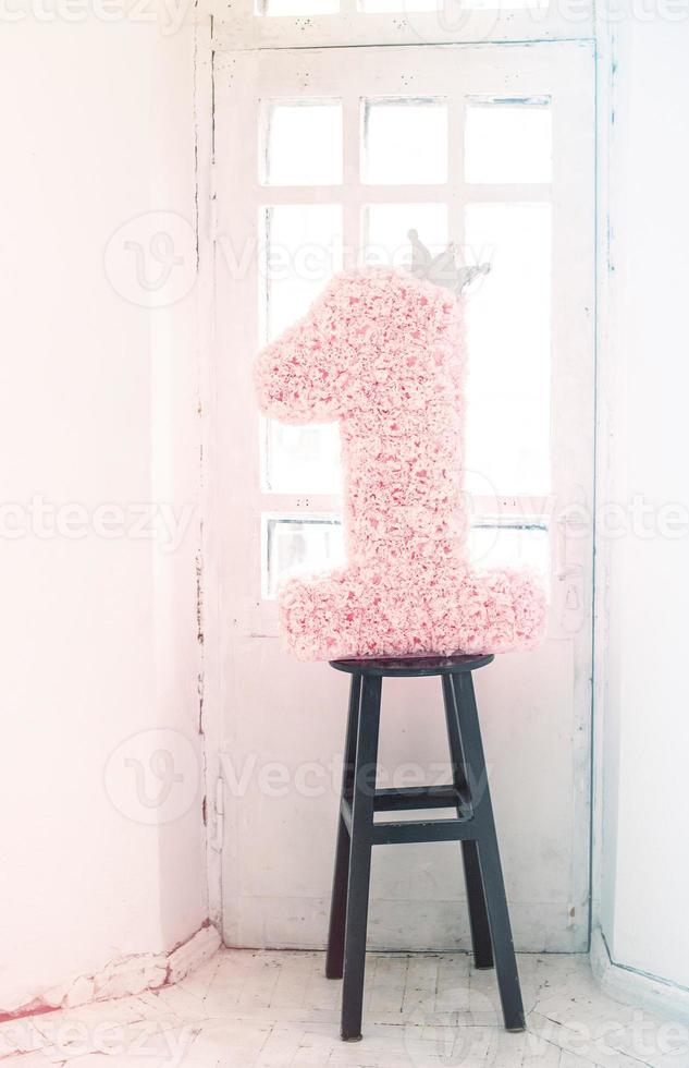 Scenery of numbers unit in flowers on a light background. Holiday one year, birthday girl baby. photo