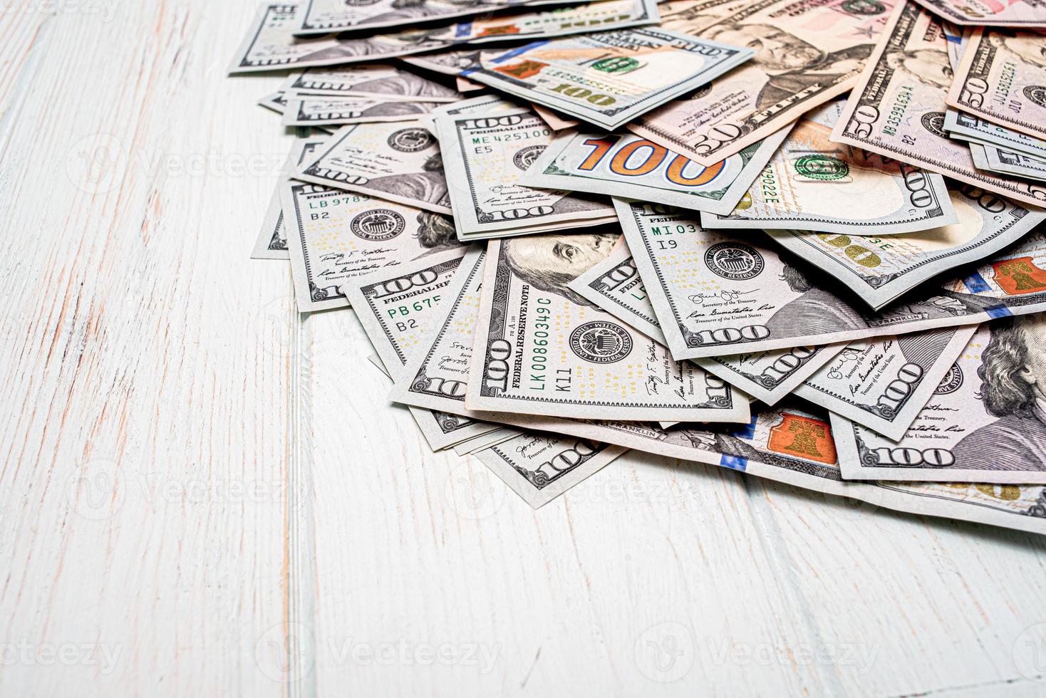 Dollars on a white wooden background. American currency bills on a white background. photo