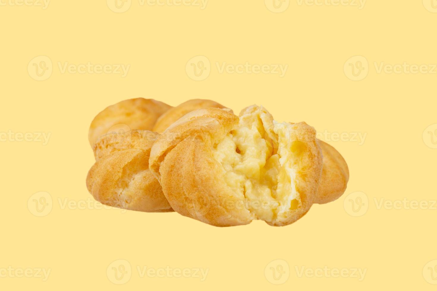 Cream puff filling, isolated on yellow  background. photo