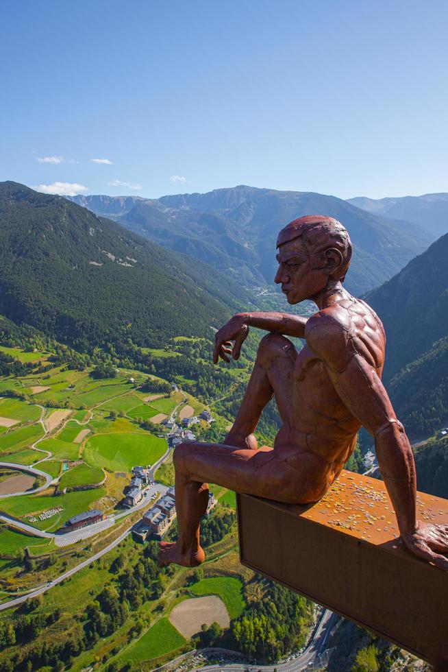 Canillo, Andorra, 2022 - Bronze Statue of a man sitting in Roc del Quer observation deck during a sunny spring day in Andorra photo