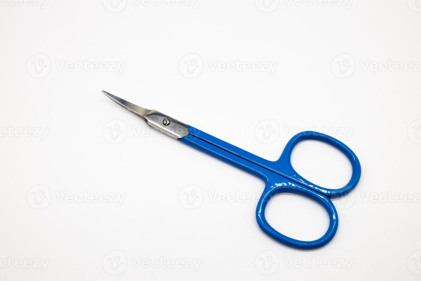 Small scissors for cutting eyebrows and nose hair. Scissors isolated on white background photo