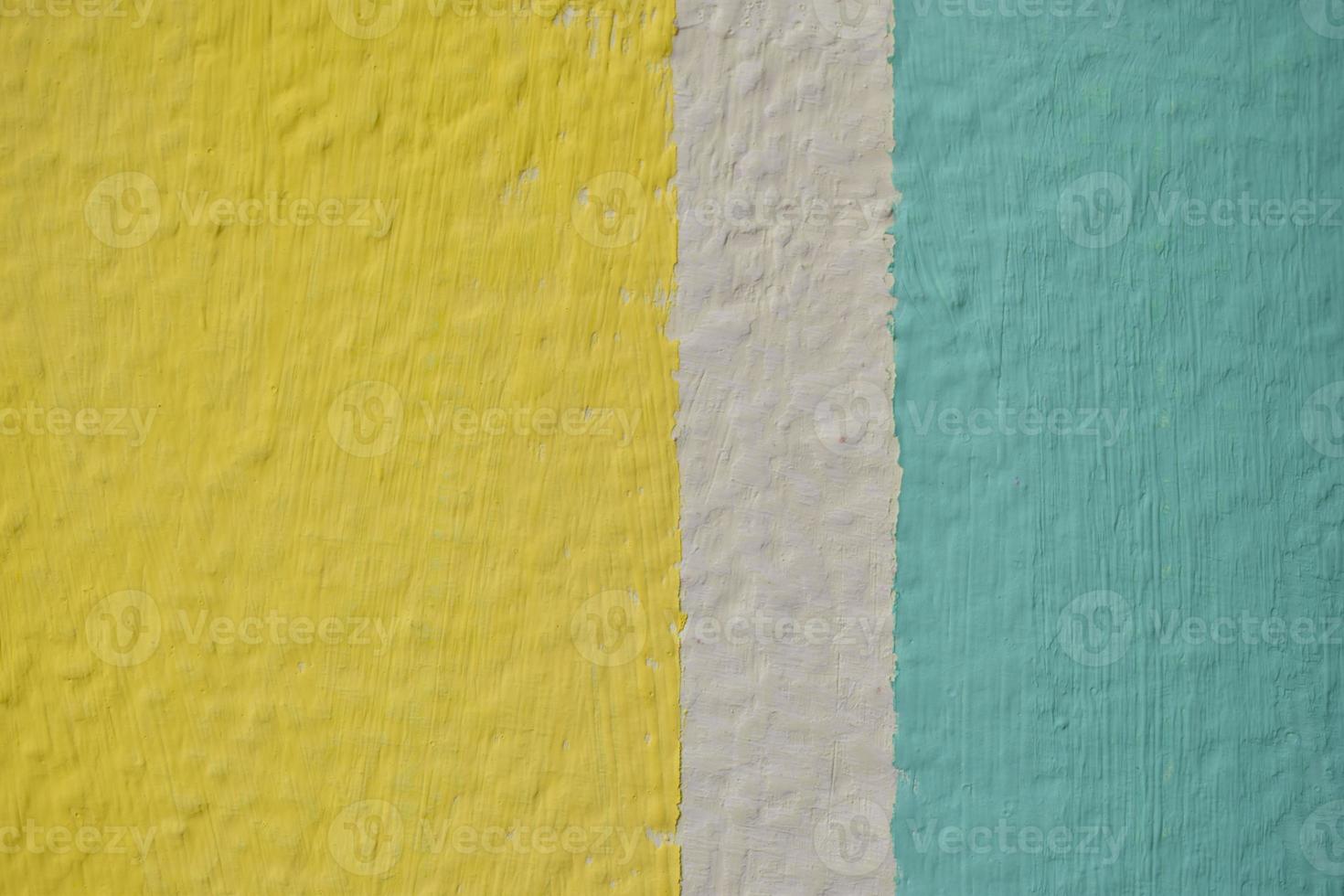 A yellow and blue wall painted with stripes and a triangle photo