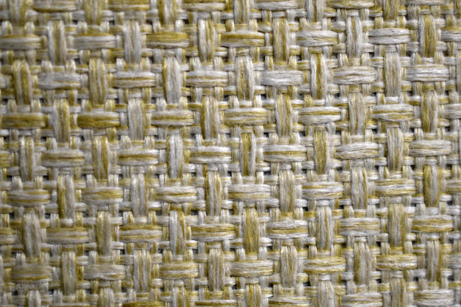 Yellow carpet fabric background close-up with threads photo