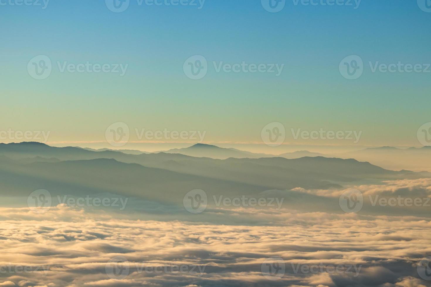 Mountain landscape of colorful sunrise in the mountains. View on foggy and cloud photo