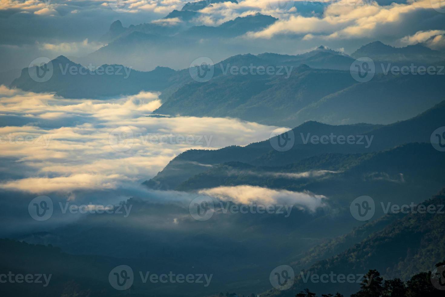 Mountain landscape of colorful sunrise in the mountains. View on foggy and cloud photo
