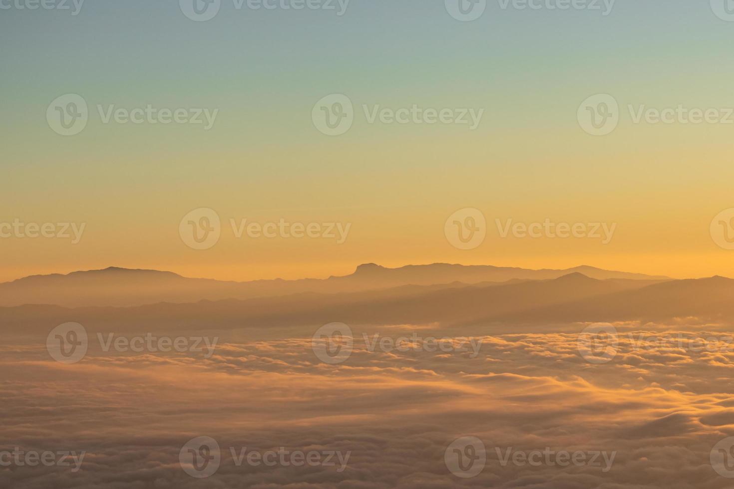 Mountain landscape of colorful sunrise in the mountains. View on foggy and cloud photo