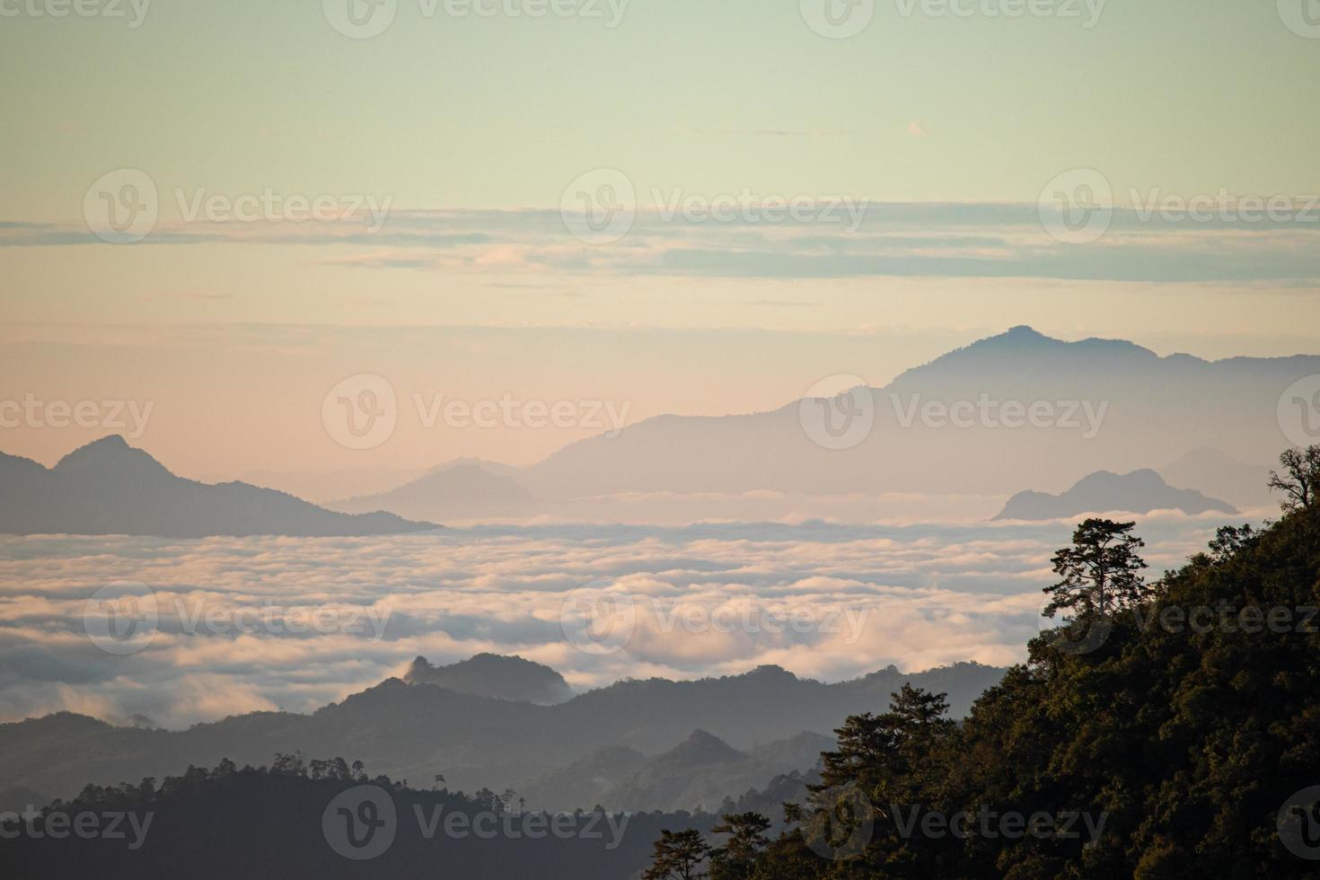 Mountain landscape of colorful sunrise in the mountains. View on foggy and cloud photo