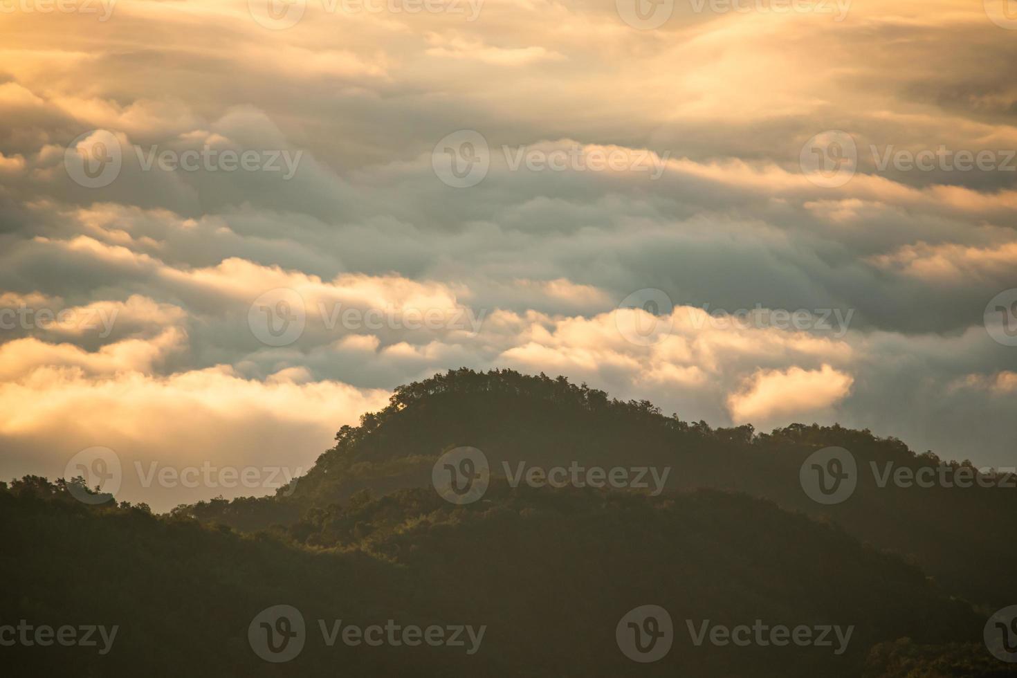 Mountain landscape of colorful sunrise in the mountains. View on foggy and cloud photo