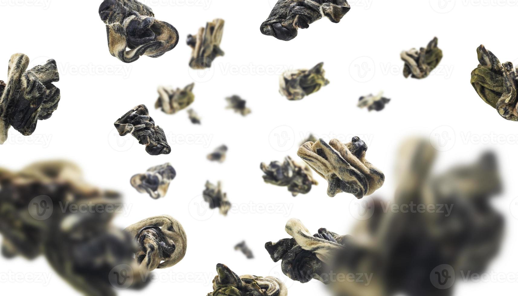 Dried Oolong tea levitates on a white background photo