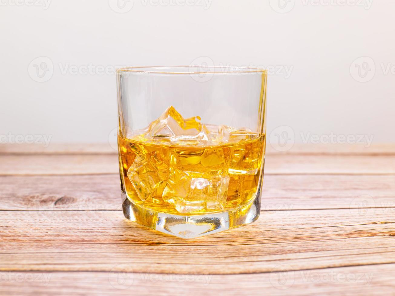 glass for liquor Translucent elements made of glass are placed on a wooden table. empty objects isolated on white background photo