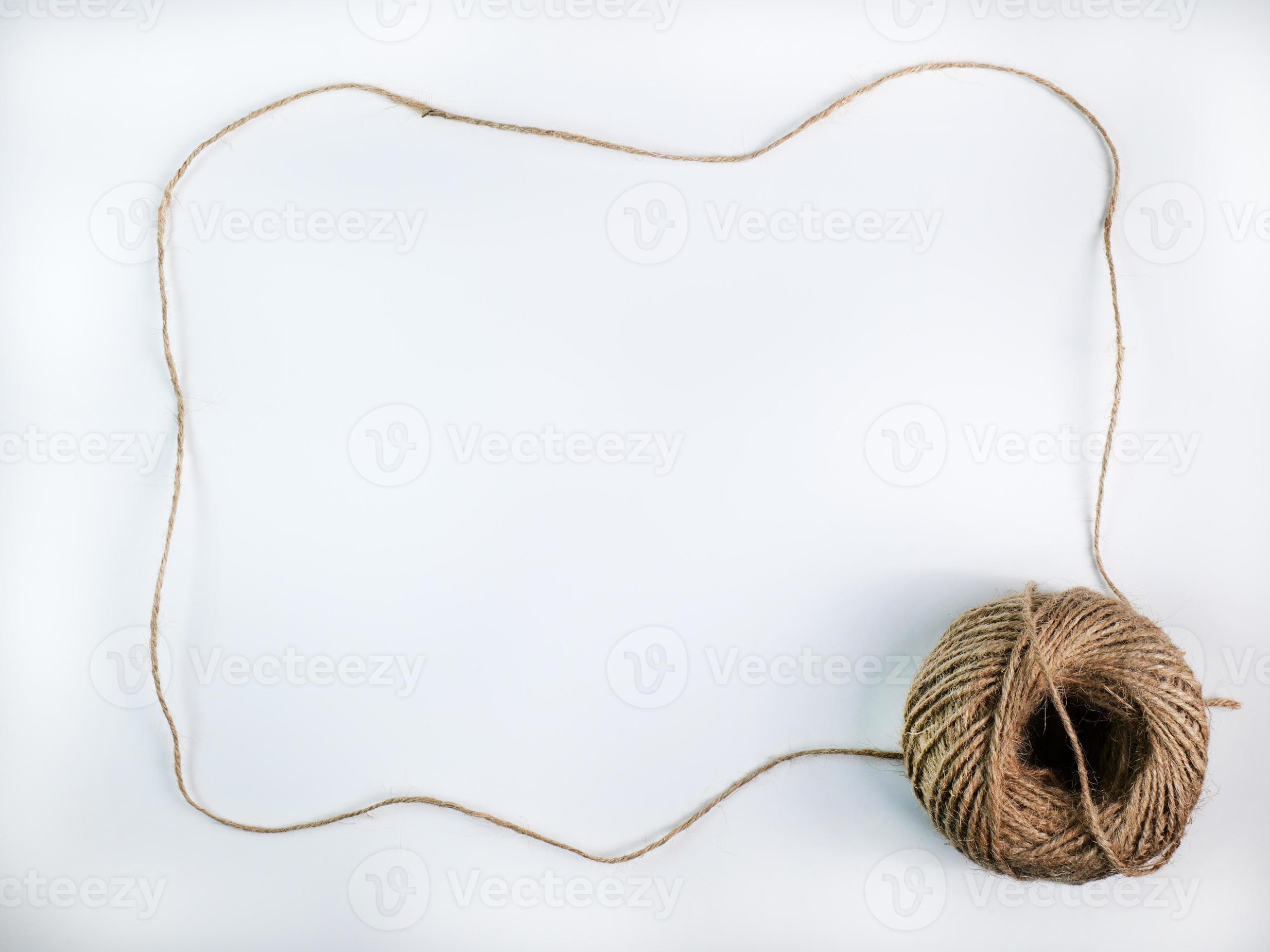 coiled raw rope Made of various fibers into a long rope. is stretched into  a frame with a space to insert text in the middle For brown crafts, white  background isolated, studio