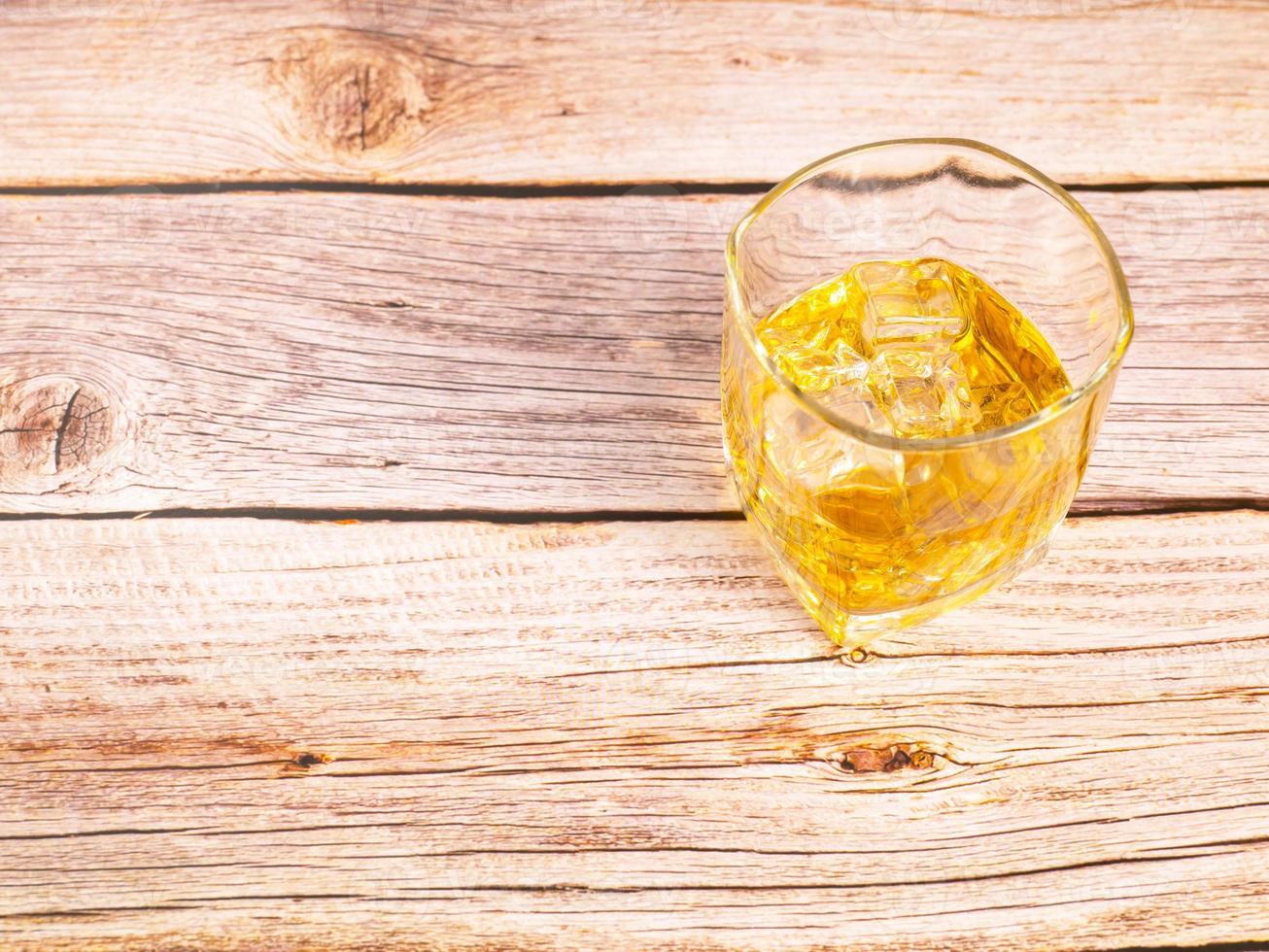 glass for liquor Translucent elements made of glass are placed on a wooden table. empty objects isolated on white background photo