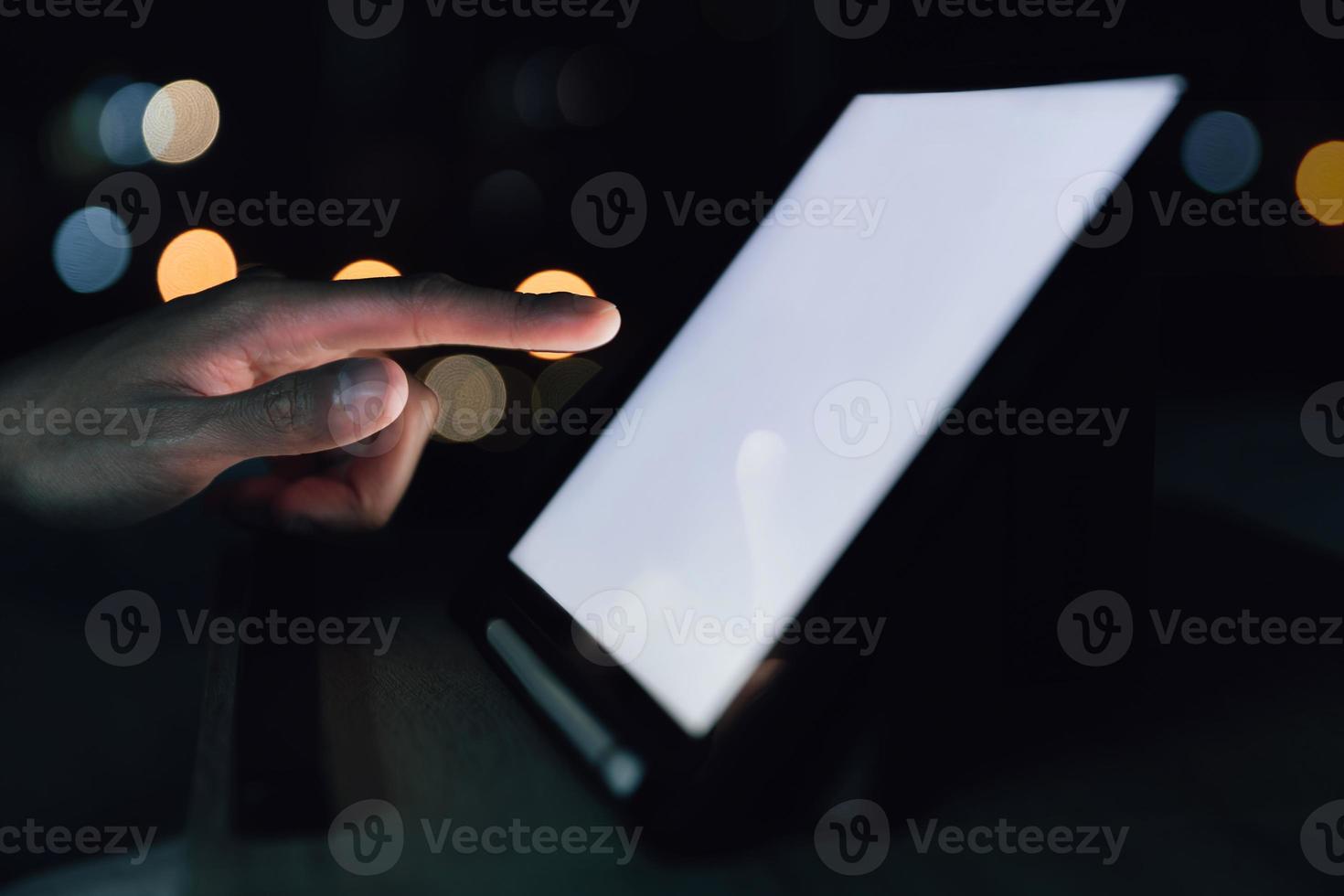 businessman touch smart phone or tablet for technology work on bed in bedroom during work from home to drive business and financial communication photo