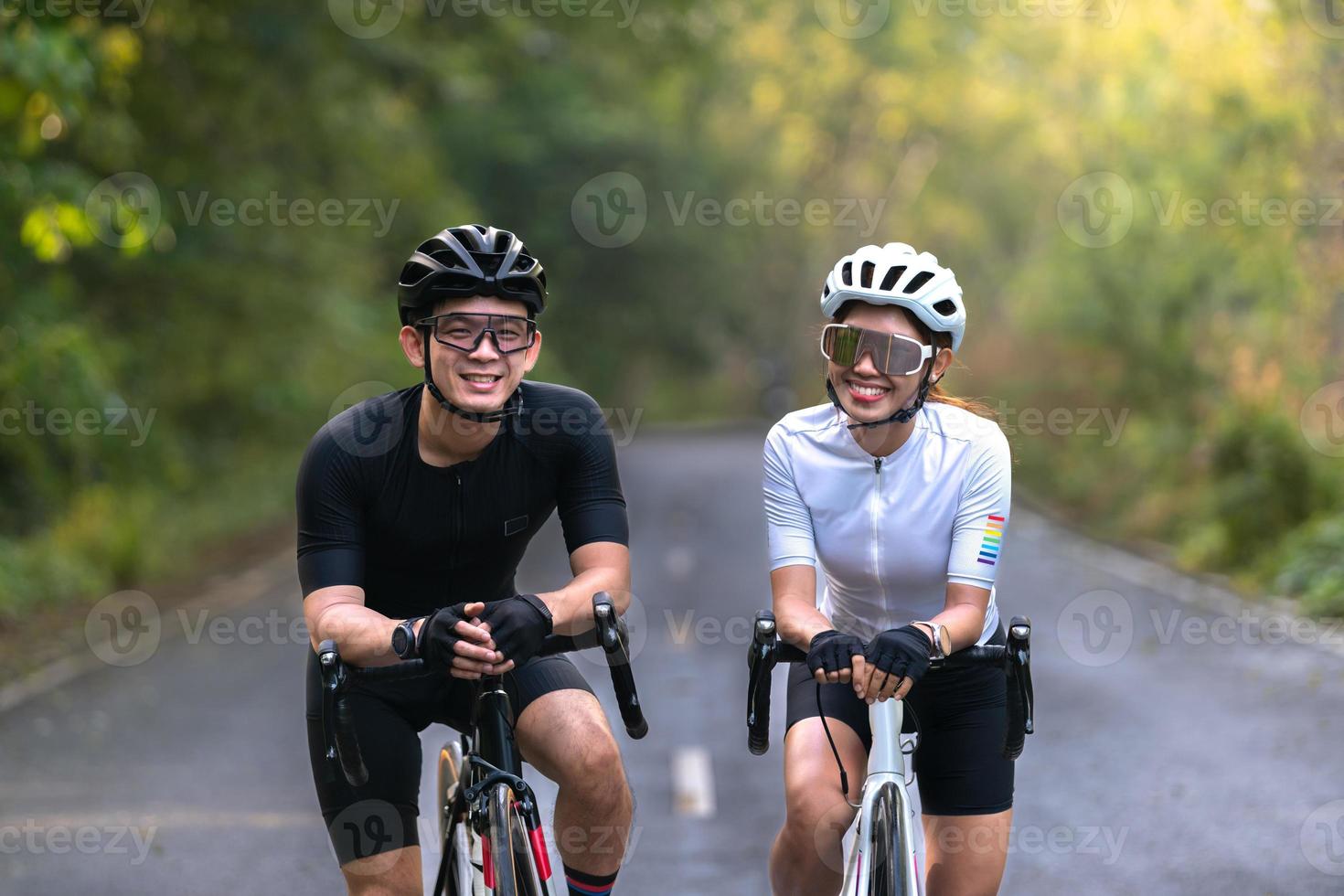 happy couple cycle or ride bicycle on rode in countryside for health life style photo