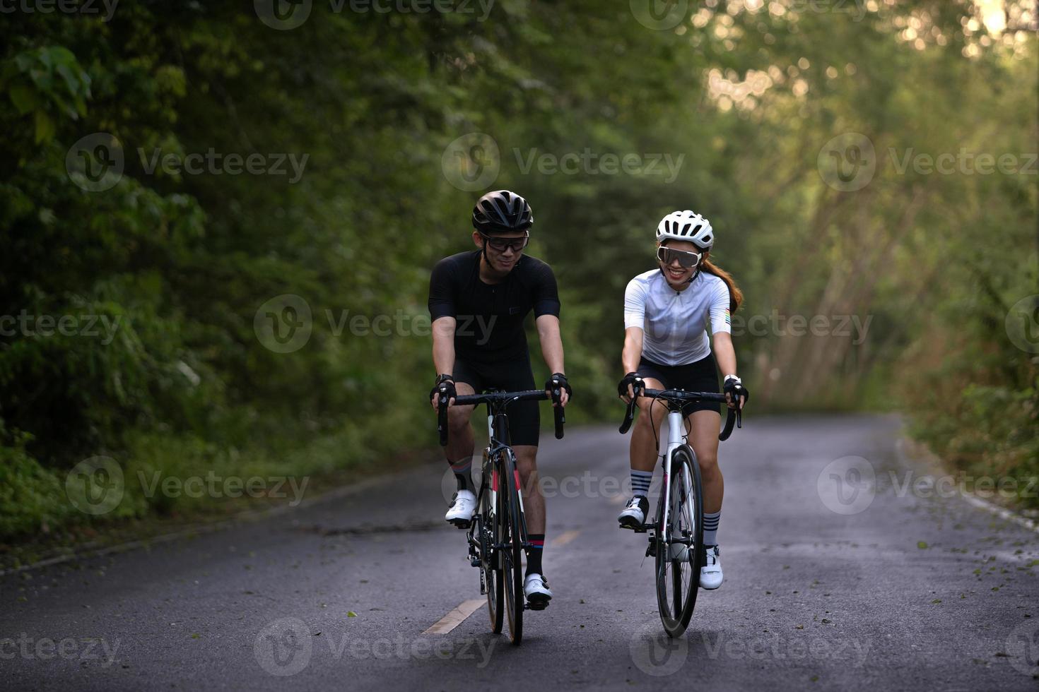 happy couple cycle or ride bicycle on rode in countryside for health life style photo