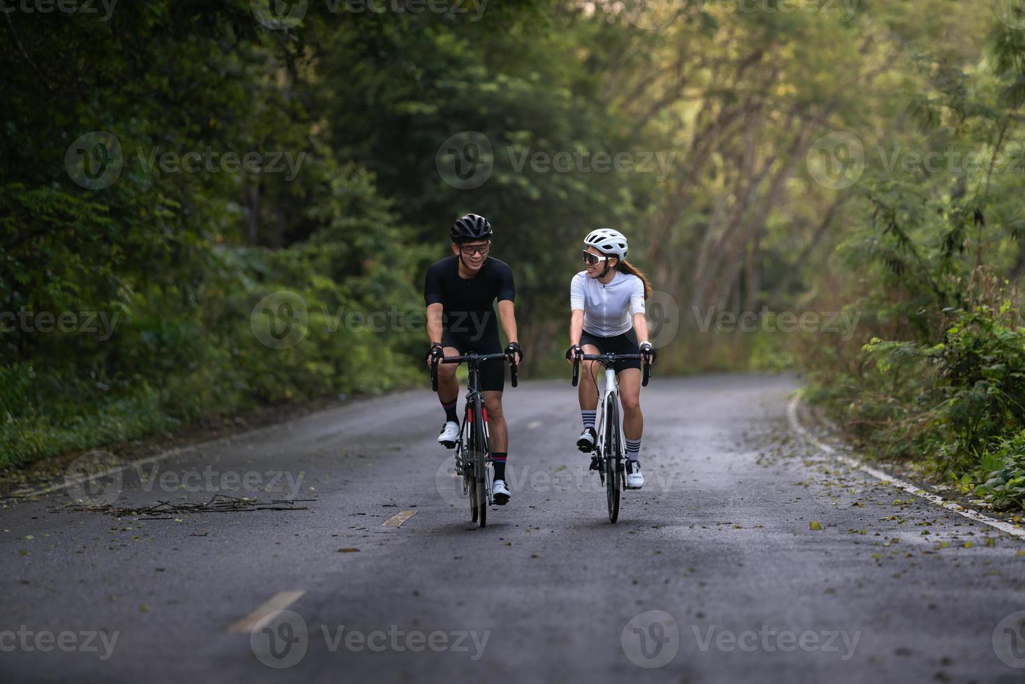 happy couple cycle or ride bicycle on rode in countryside for health life style photo