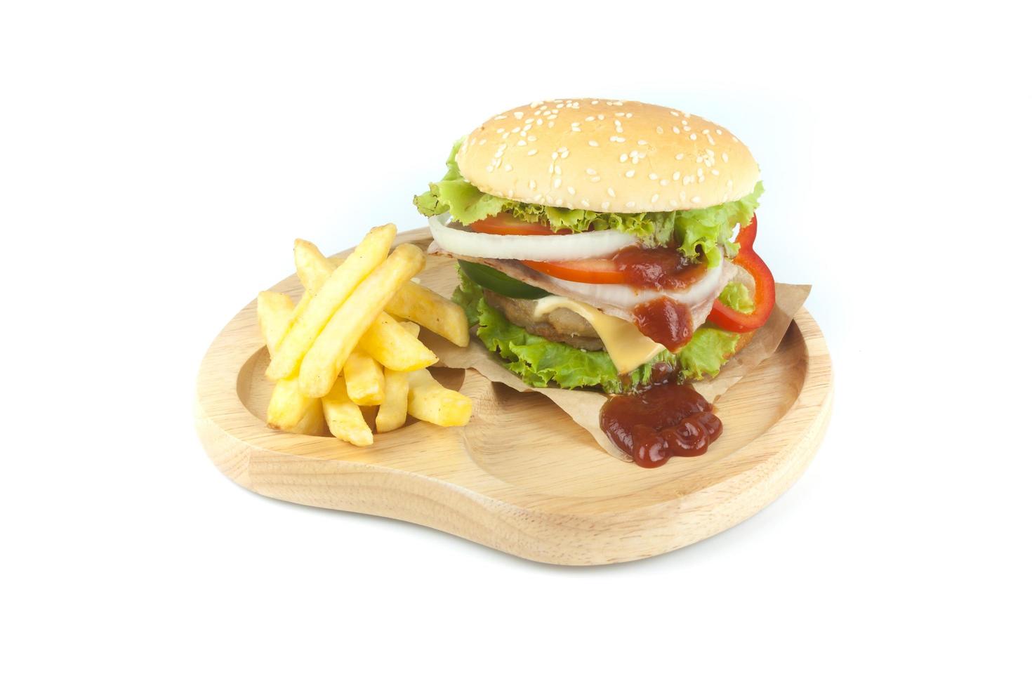 Pork hamburger Homemade with grilled bacon contains vegetables, cheese, lettuce, onion, chilli, spices in a wooden dish isolated on white backgroud photo